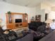 Cozy living room featuring vaulted ceilings, entertainment center, and comfortable seating at 11185 Heathrow Ave, Spring Hill, FL 34609