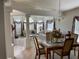 Spacious living room featuring high ceilings, neutral color palette, and dining area at 11185 Heathrow Ave, Spring Hill, FL 34609