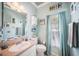 Cozy bathroom with soft aqua walls, beach themed decor, and a tub with a curtain at 11519 Cypress Reserve Dr, Tampa, FL 33626