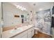 Nautical themed bathroom featuring double sinks, large mirror, and tub with ship-themed curtain at 11519 Cypress Reserve Dr, Tampa, FL 33626