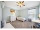 A light-filled bedroom with simple decor, a desk, and a comfortable bed at 11519 Cypress Reserve Dr, Tampa, FL 33626
