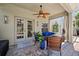 A cozy covered patio with comfortable seating and a ceiling fan at 11519 Cypress Reserve Dr, Tampa, FL 33626