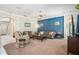 Comfortable living room with a ceiling fan, plush carpeting, and a striking blue accent wall at 11519 Cypress Reserve Dr, Tampa, FL 33626