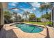 Screened-in pool area with brick patio and view of the well-manicured backyard at 11519 Cypress Reserve Dr, Tampa, FL 33626
