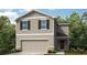 Charming two-story home boasts a two-car garage, complemented by lovely landscaping and neutral tones at 12400 Gust Ct, Hudson, FL 34669