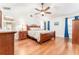 Spacious bedroom features a ceiling fan, wood floors, and natural light from the window at 12408 Wexford Hills Rd, Riverview, FL 33569