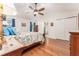 Bedroom with wood floors, large closets, and a ceiling fan at 12408 Wexford Hills Rd, Riverview, FL 33569