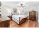 Comfortable bedroom with wood furniture, hardwood floors, and natural light at 12408 Wexford Hills Rd, Riverview, FL 33569