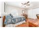 Bedroom features wood floors, natural light from the window, and a ceiling fan at 12408 Wexford Hills Rd, Riverview, FL 33569