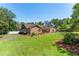 Well-maintained brick house with lush green lawn and mature trees at 12408 Wexford Hills Rd, Riverview, FL 33569