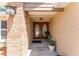 Close-up of the inviting front entrance with double doors, potted plants, and a brick accent wall at 12408 Wexford Hills Rd, Riverview, FL 33569