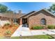 Charming brick home featuring a well-manicured lawn, complemented by mature trees and lush landscaping at 12408 Wexford Hills Rd, Riverview, FL 33569
