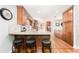 Well-lit kitchen with wood cabinetry, stainless steel appliances, and a peninsula with seating at 12408 Wexford Hills Rd, Riverview, FL 33569