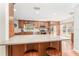 Well-equipped kitchen with wood cabinets, stainless steel appliances, and a large island with seating at 12408 Wexford Hills Rd, Riverview, FL 33569