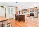 Spacious kitchen with an island, wood cabinets, stainless steel appliances, and hardwood floors at 12408 Wexford Hills Rd, Riverview, FL 33569