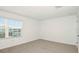 Bedroom featuring neutral carpet, large window, and ample natural light at 12414 Gust Ct, Hudson, FL 34669