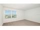 Bedroom featuring neutral carpet, large window, and ample natural light at 12414 Gust Ct, Hudson, FL 34669