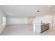 Open-concept living room with tile flooring and abundant natural light at 12414 Gust Ct, Hudson, FL 34669