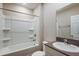 Bright bathroom featuring a shower and tub combination and a single sink vanity with grey countertop at 13034 Wellspring Dr, Lithia, FL 33547