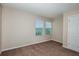 This bedroom features plush brown carpeting and two sunlit windows with blinds for natural light at 13034 Wellspring Dr, Lithia, FL 33547