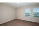 This bedroom features neutral walls, carpet, and two windows allowing for ample natural light at 13034 Wellspring Dr, Lithia, FL 33547