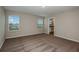 This bedroom features neutral walls, carpet, and two windows allowing for ample natural light at 13034 Wellspring Dr, Lithia, FL 33547