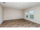 Bright bedroom with neutral walls, wood flooring and windows with blinds at 13034 Wellspring Dr, Lithia, FL 33547