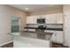 Bright kitchen featuring an island with light countertops, stainless steel appliances and white cabinetry at 13034 Wellspring Dr, Lithia, FL 33547