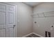 This laundry room features vinyl flooring and a wire rack for storage at 13034 Wellspring Dr, Lithia, FL 33547