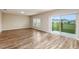 Open concept living area with neutral walls, wood flooring and sliding glass doors leading to the backyard at 13034 Wellspring Dr, Lithia, FL 33547