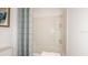 Clean bathroom featuring a tub with shower with built in shelving and a blue striped shower curtain at 13470 Tropical Breeze Way, Hudson, FL 34669