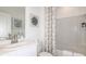Bathroom showcasing a white vanity, modern faucet, and bathtub with shower with patterned curtain at 13470 Tropical Breeze Way, Hudson, FL 34669