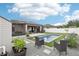Beautiful backyard features a refreshing pool, stylish patio, and lush landscaping for ultimate outdoor enjoyment at 14227 Alistar Manor Dr, Wimauma, FL 33598