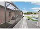 Enclosed patio leads to backyard oasis with pool and storage shed at 14227 Alistar Manor Dr, Wimauma, FL 33598