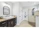 Well-lit bathroom with a vessel sink, dark cabinets, granite counters, and a glass-enclosed shower at 14227 Alistar Manor Dr, Wimauma, FL 33598