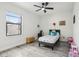 bedroom with neutral colors, hardwood floors, and natural light from a large window at 14227 Alistar Manor Dr, Wimauma, FL 33598
