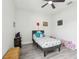 Bright bedroom featuring a ceiling fan, grey plank flooring, and a comfortable bed at 14227 Alistar Manor Dr, Wimauma, FL 33598