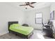 Bedroom with wood-look flooring, ceiling fan, and a computer setup for work or play at 14227 Alistar Manor Dr, Wimauma, FL 33598