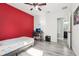 Bedroom with wood-look floors and a red accent wall with space for a computer setup at 14227 Alistar Manor Dr, Wimauma, FL 33598
