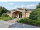 Inviting clubhouse entrance with stone archway and well-maintained landscaping at 14227 Alistar Manor Dr, Wimauma, FL 33598
