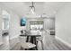 Open-concept dining area with sleek floors, contemporary lighting, and backyard views at 14227 Alistar Manor Dr, Wimauma, FL 33598