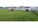 Fenced dog park with playhouse and pet-friendly amenities for resident's canine companions at 14227 Alistar Manor Dr, Wimauma, FL 33598