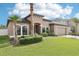 Inviting home with a well-maintained lawn, mature palms, and a welcoming entrance at 14227 Alistar Manor Dr, Wimauma, FL 33598