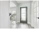Light-filled foyer featuring wood floors, office access, and glass-paneled entry door at 14227 Alistar Manor Dr, Wimauma, FL 33598