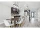 Open kitchen with dark cabinets, stainless steel appliances, large center island, and attached dining area at 14227 Alistar Manor Dr, Wimauma, FL 33598