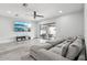 Inviting living room with contemporary flooring, large TV, and access to outdoor area at 14227 Alistar Manor Dr, Wimauma, FL 33598