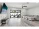 Spacious living room with modern flooring and sliding glass doors leading to the pool at 14227 Alistar Manor Dr, Wimauma, FL 33598