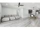 Bright living room with sleek floors, comfortable sectional sofa, and open layout at 14227 Alistar Manor Dr, Wimauma, FL 33598