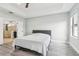 Bright bedroom with ensuite bathroom and tray ceilings at 14227 Alistar Manor Dr, Wimauma, FL 33598