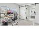 Office with natural light, gray plank flooring, modern desk and chair, and barn door at 14227 Alistar Manor Dr, Wimauma, FL 33598